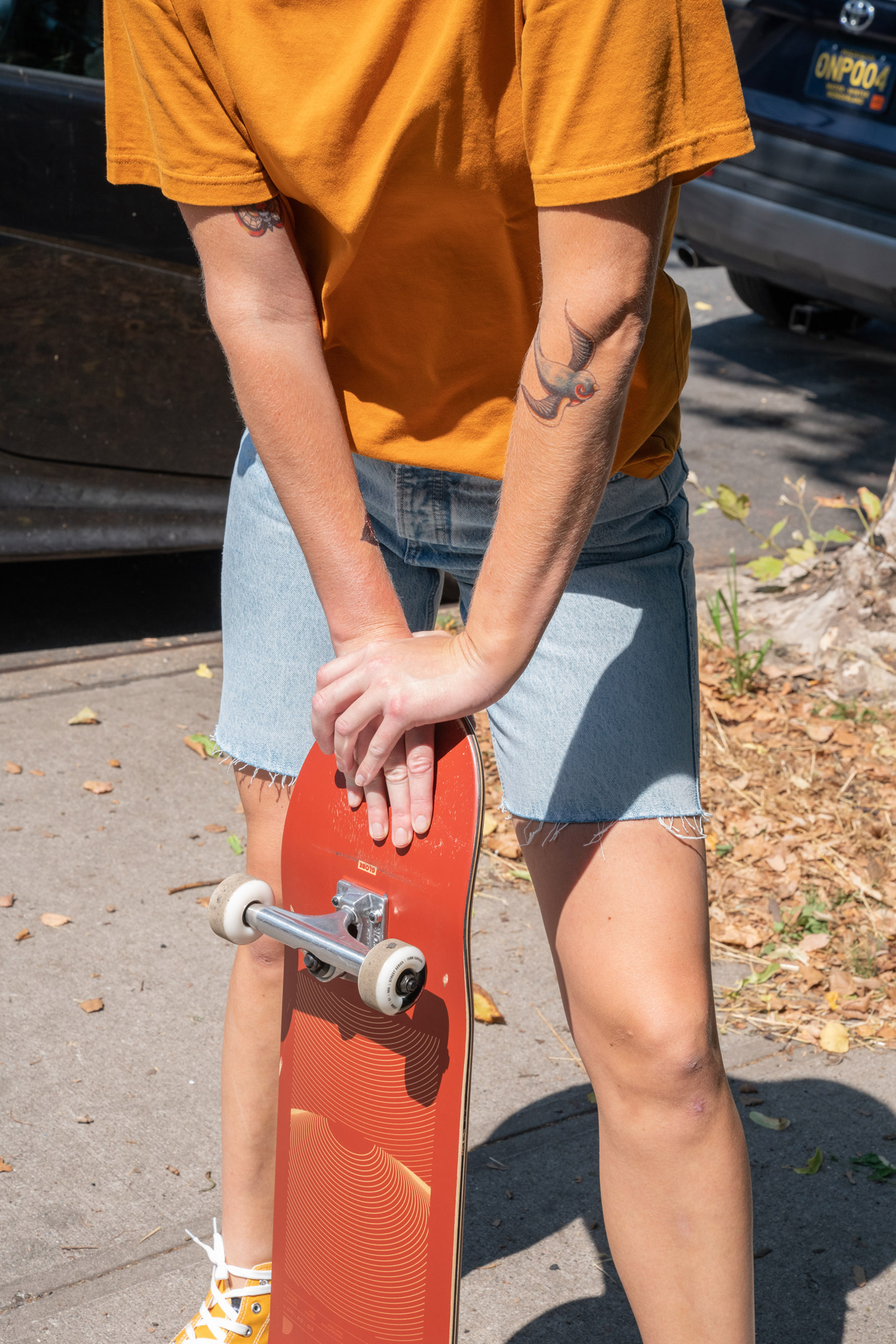 A woman leaning on her skateboard