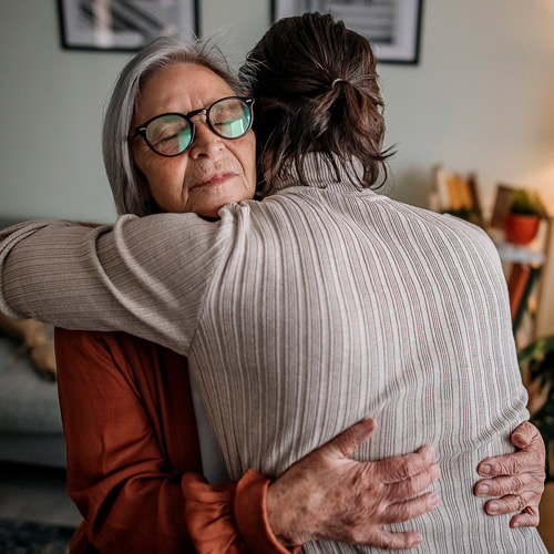 A mother and daughter embrace