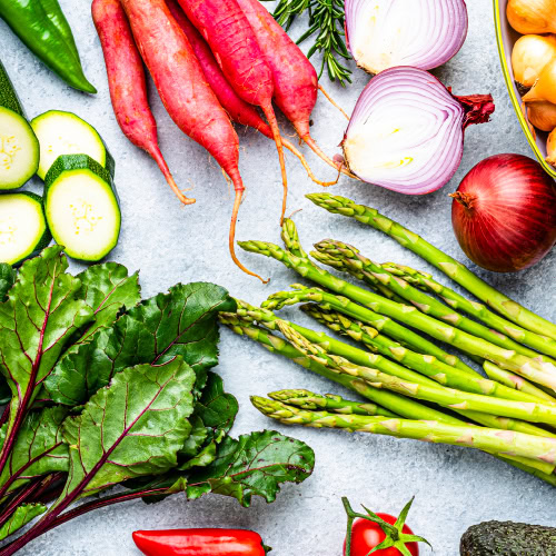 An overhead array of colorful vegetables on a table