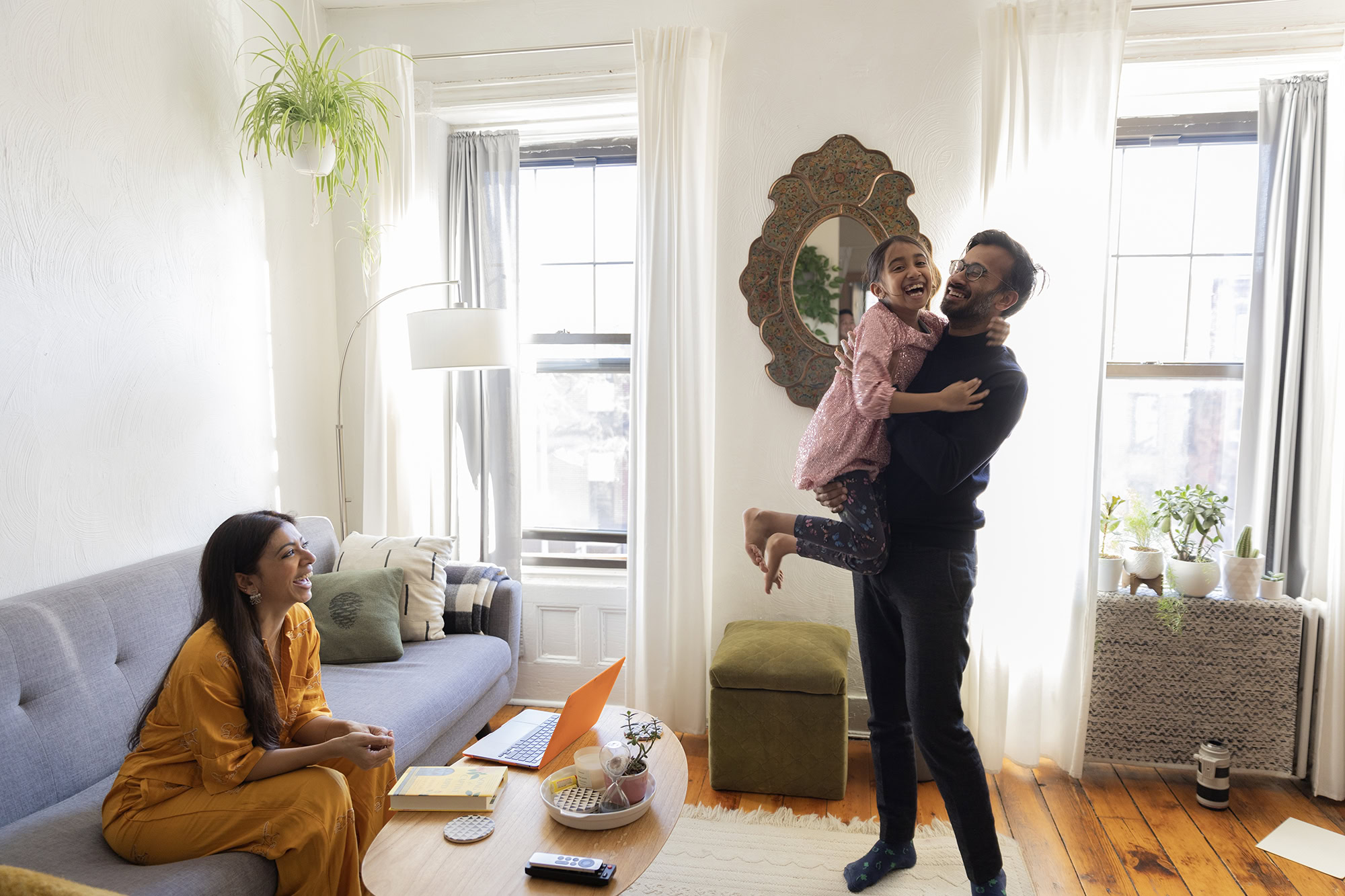 Happy parent and child reviewing Child Health Plus enrollment forms with a MetroPlusHealth representative in NYC.
