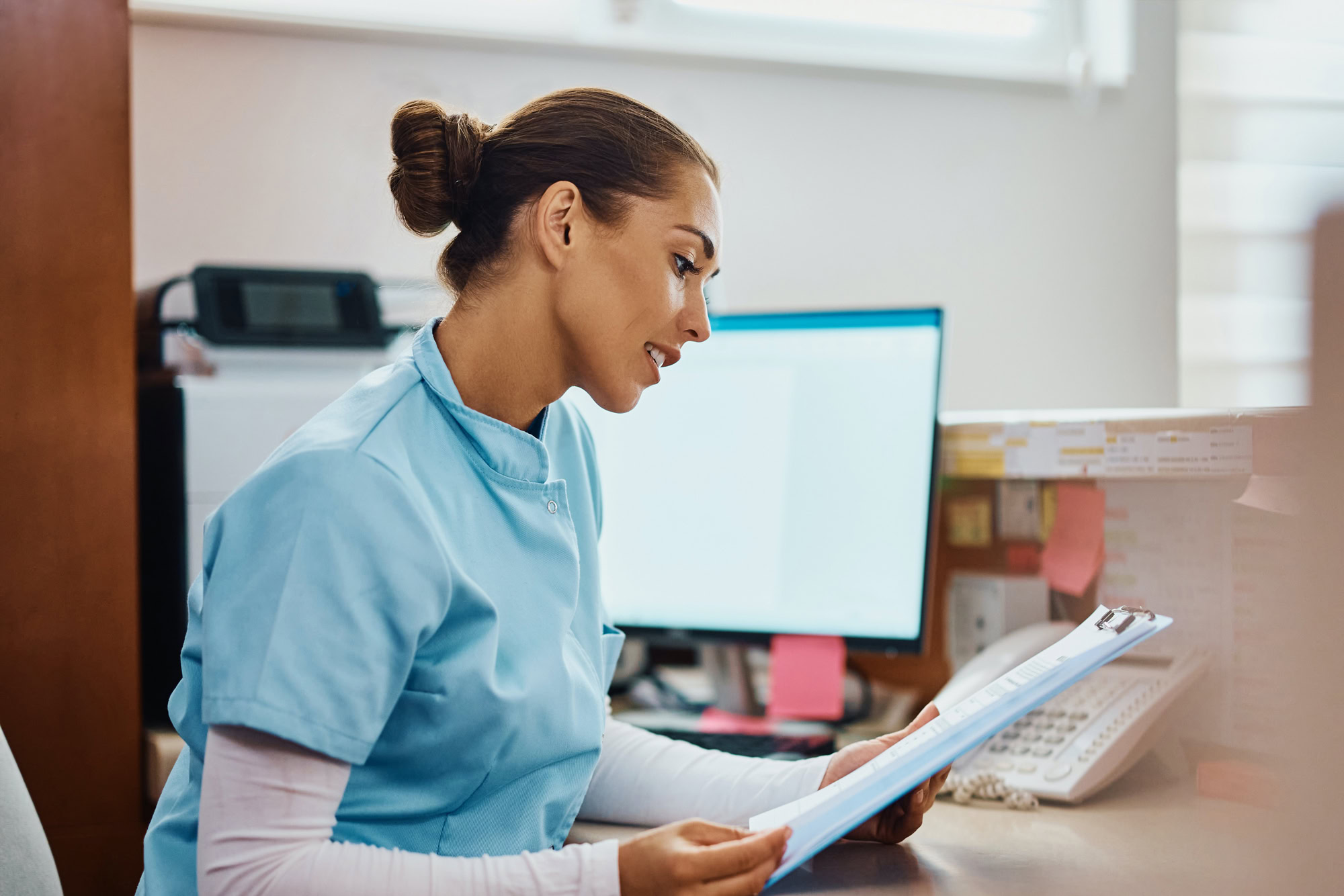 nurse-checking-patients-chart-at-desk