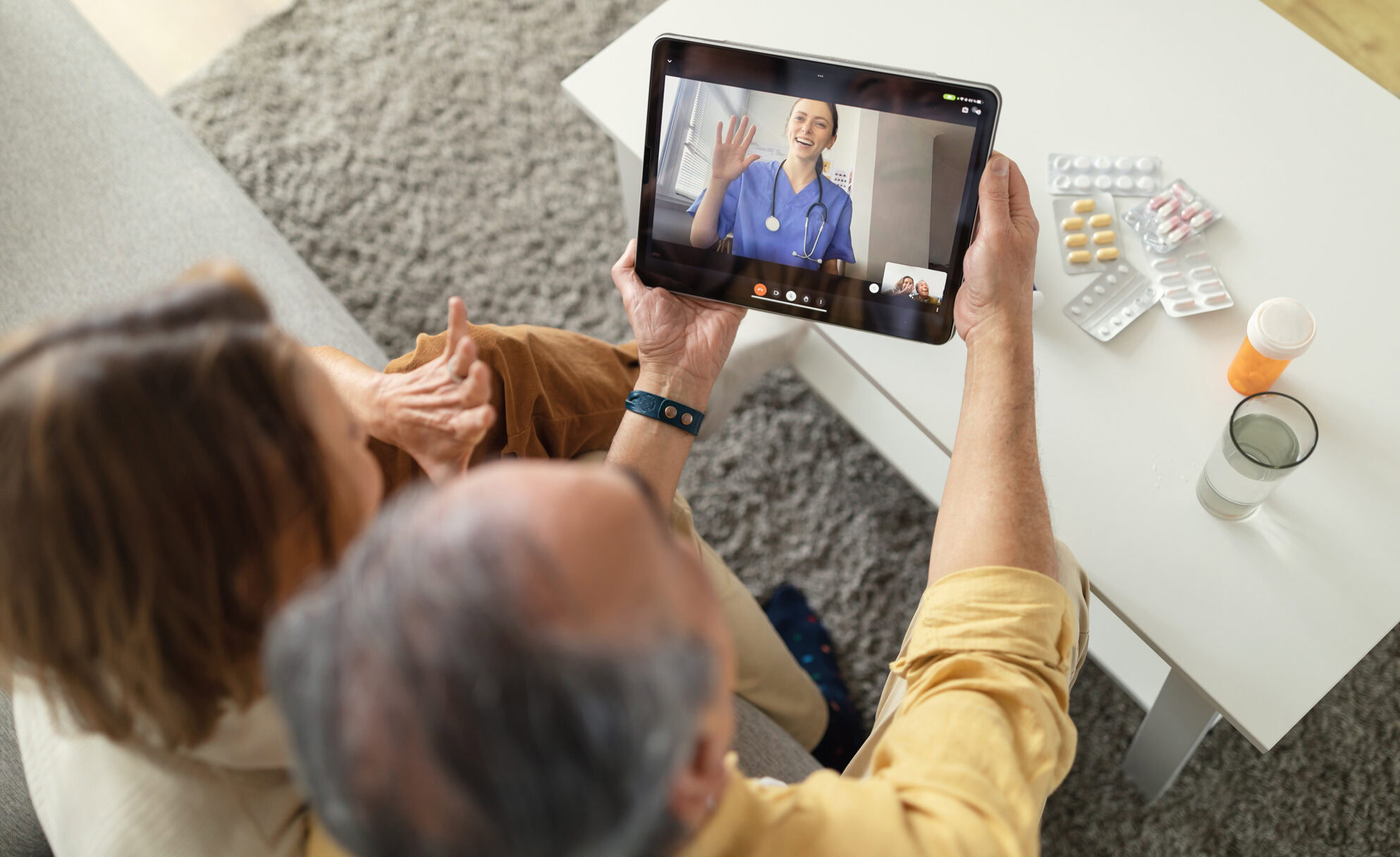 Telemedicine services. Senior spouses having video call with online doctor and getting professional health consultation