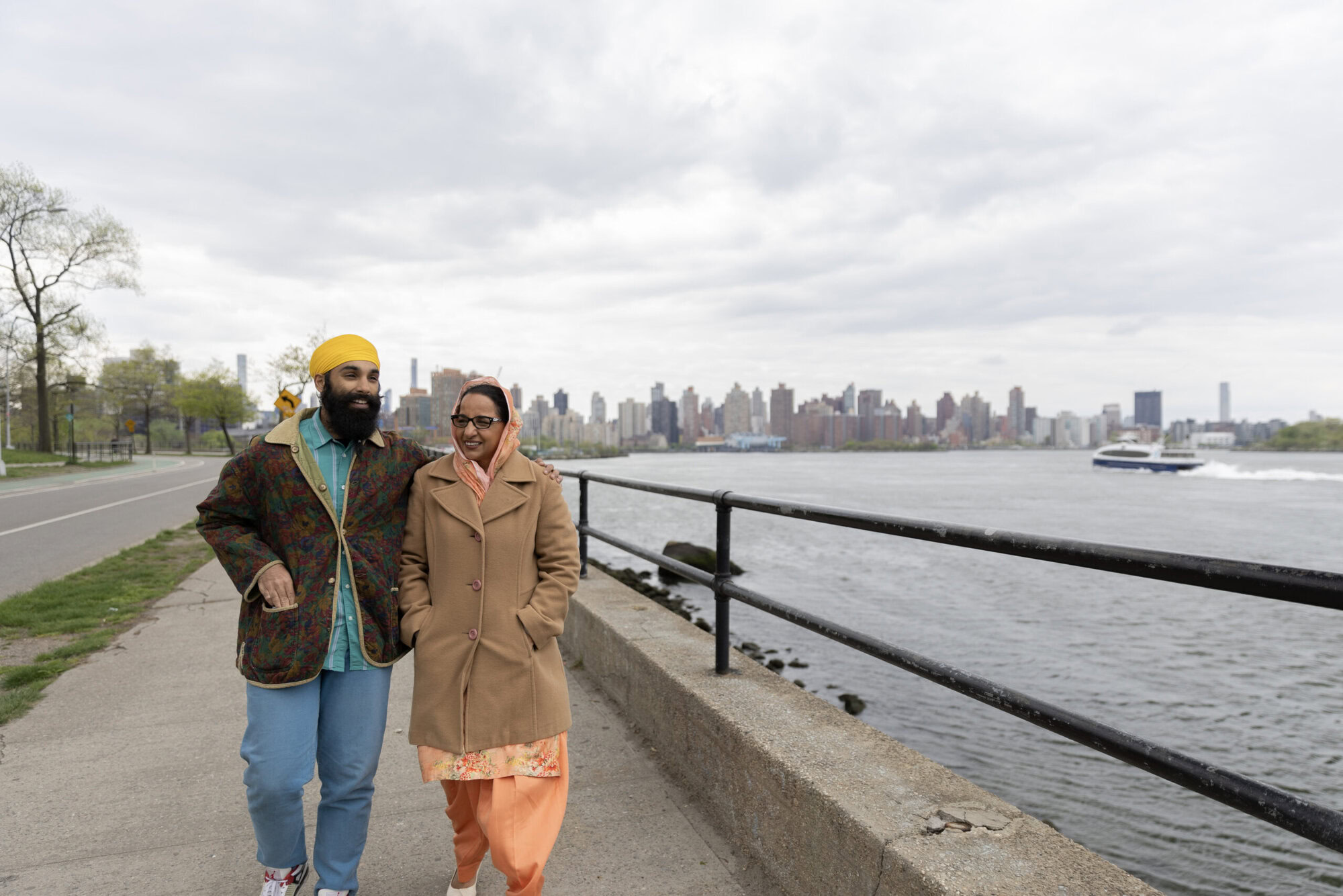 Senior adult reviewing Medicare enrollment documents with MetroPlusHealth representative in New York.