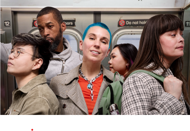 Diverse NYC employees working together in an office with MetroPlusHealth GoldCare Plan workplace health coverage.