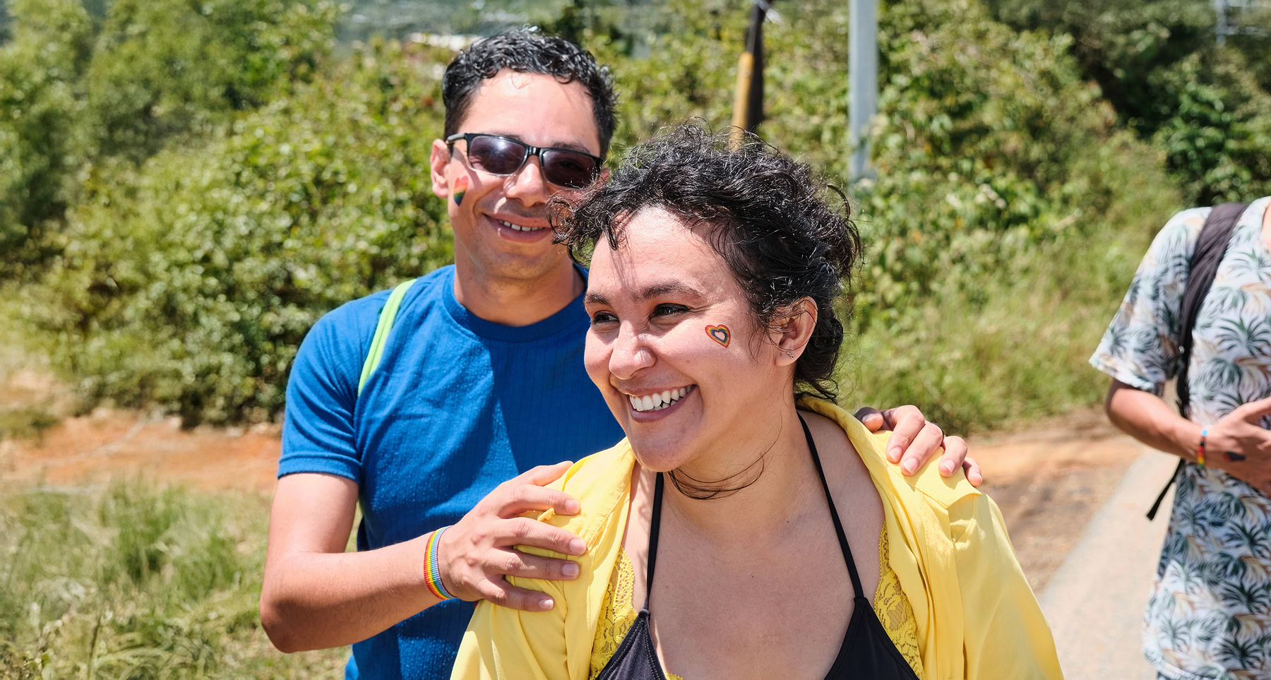 Diverse New Yorkers smiling outdoors, representing affordable, no-premium health coverage through the MetroPlusHealth Essential Plan.