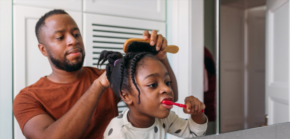 MetroPlusHealth member smiling while holding a gift card as part of the Member Rewards program.