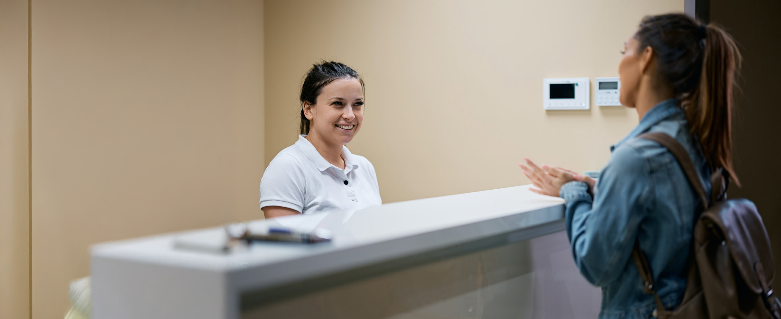 Pediatric healthcare provider conducting a wellness screening with a young child while a parent participates in the visit, highlighting preventive healthcare and developmental services.
