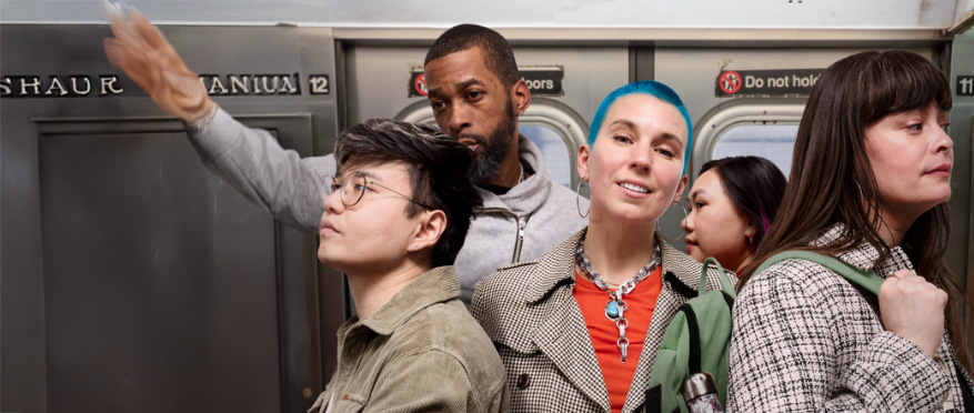 Diverse NYC employees working together in an office with MetroPlusHealth GoldCare Plan workplace health coverage.